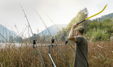 Pre-baiting for carp - fisherman using throwing stick