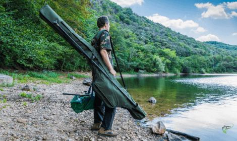 Margin fishing for carp - Man holding carp gear looking for fish