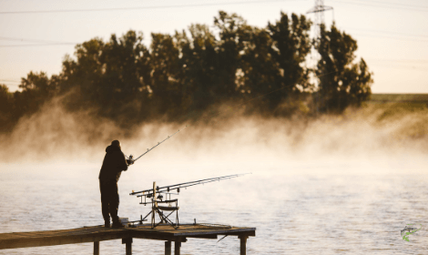 Carp fishing tips - man casting into windy lake