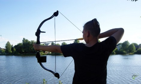how-to-bow-fish-for-carp-man-shooting-bow-beside-river