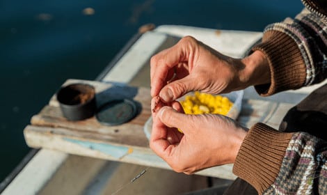 How to put worms on a hook - Angler piercing hook through a worm