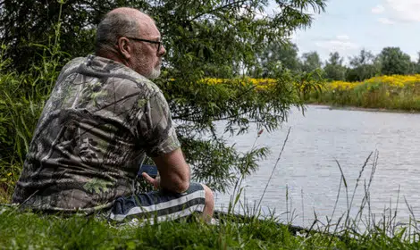 Why is carp fishing so hard - Carp angler watching over small lake
