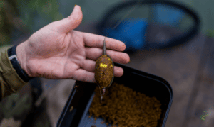 How do you make the perfect method feeder mix - Man holding method feeder with mix underneath